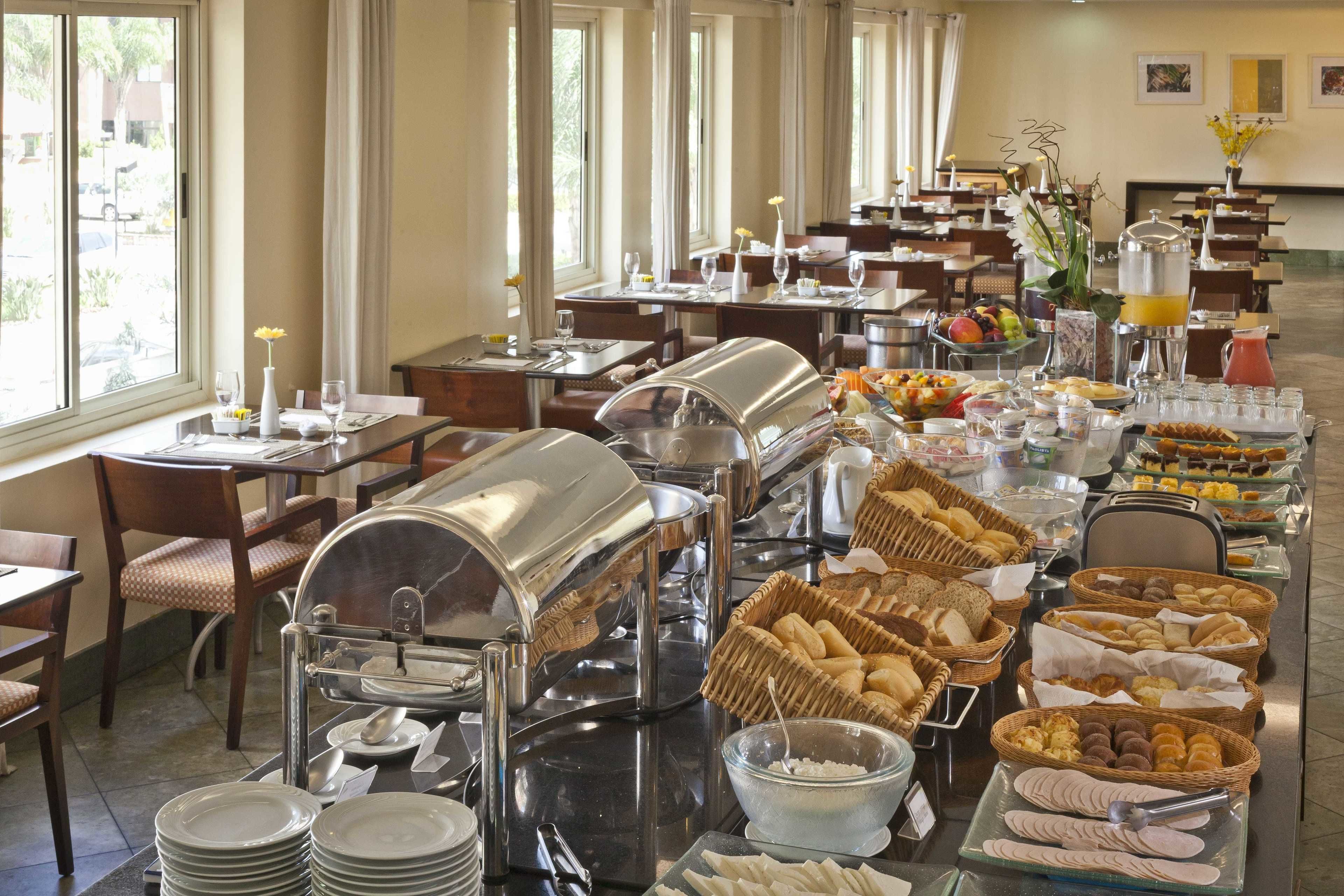 A buffet with various food items and a self-service beverage station.