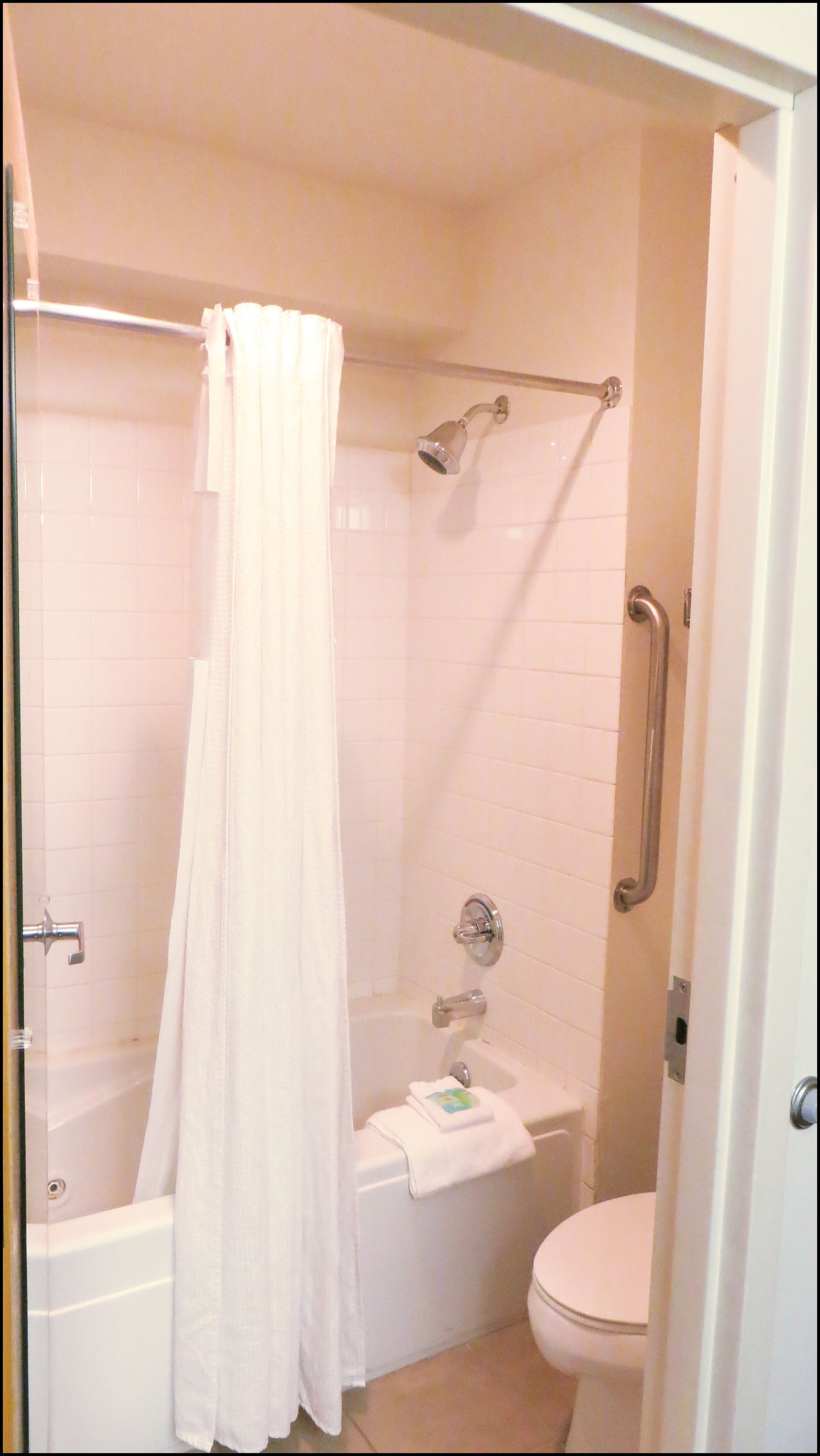 A bathroom with a shower, a bathtub, and a toilet.