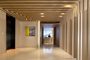 Contemporary architecture features clean lines and a minimalist aesthetic, leading to a reception area.