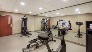 A gym with various exercise equipment, including treadmills and weight machines, and a mirrored wall. - Sleep Inn & Suites North Mobile Saraland (Saraland)