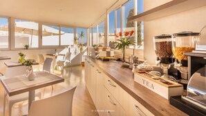 A modern kitchen with a long counter, a coffee machine, and a tea station. - Nonna Nina (Avola)