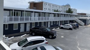 Um motel com vários andares e estacionamento.