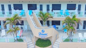A hotel with multiple balconies, outdoor seating, and palm trees. - The Diane Oceanfront Suites (Hollywood)