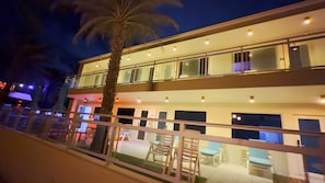 A multi-story hotel with balconies, outdoor seating, and palm trees. - The Diane Oceanfront Suites (Hollywood)