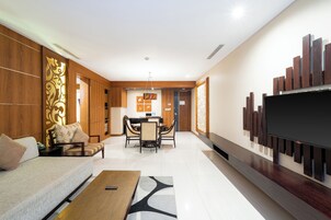 Una sala de estar moderna con un sofá, una mesa de centro y un televisor montado en la pared.