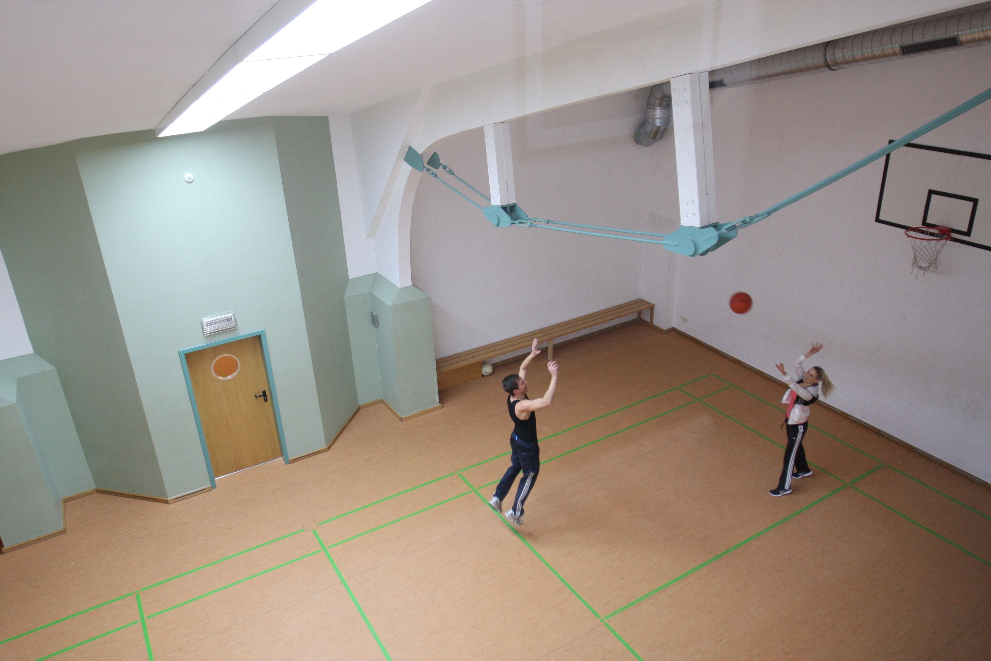 A basketball court with a hoop and a net.