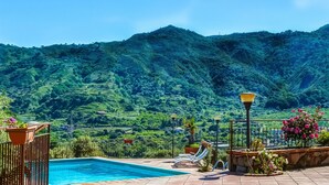 A pool area with a view of lush green mountains. - Il Poggio Luxury Country Resort (Graniti)