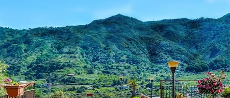 A pool area with a view of lush green mountains.