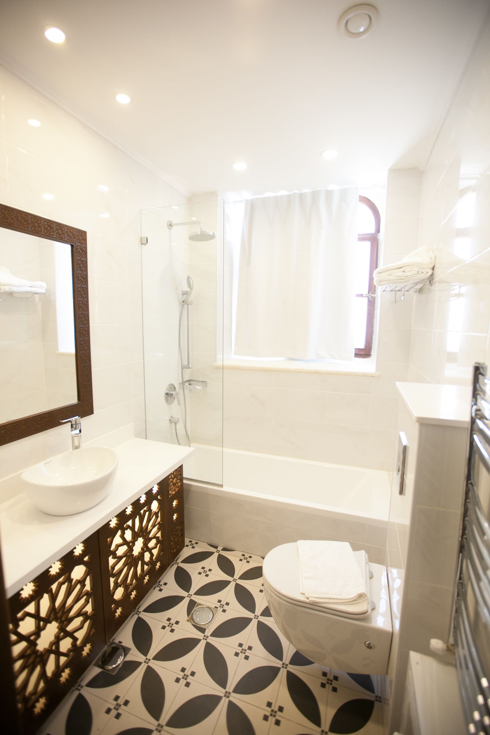 A modern bathroom with a bathtub, toilet, and sink.