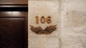 A wall with the number '106' and a decorative leaf pattern.