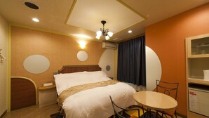 A hotel room with a bed, bedside table, chair, and a small table with a chair. - Hotel Fine Aroma Dotonbori (Osaka)