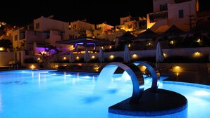 A swimming pool with a water feature and a covered seating area. - Sentido Bellazure (Bodrum)