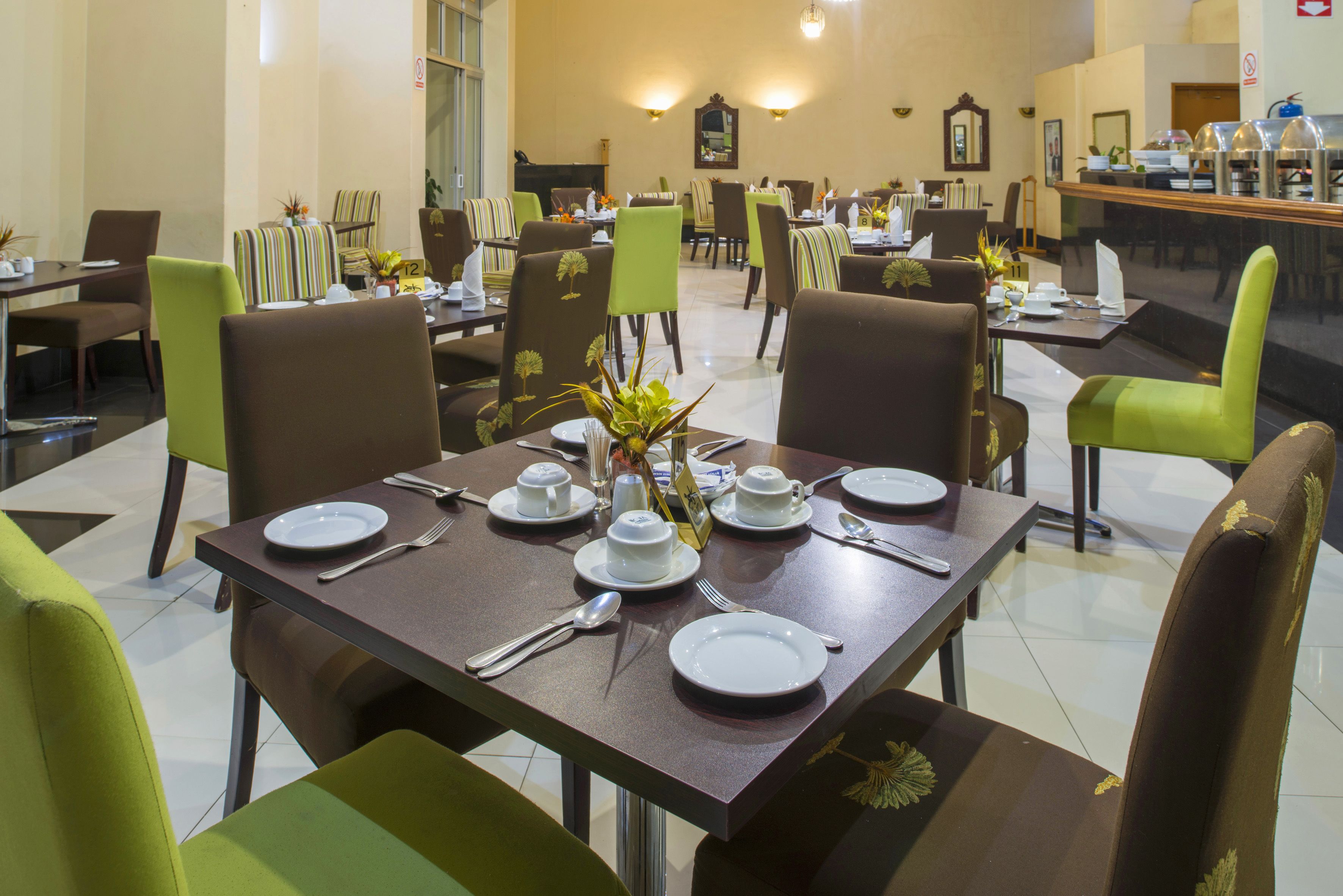 A restaurant with multiple tables, chairs, and a counter.