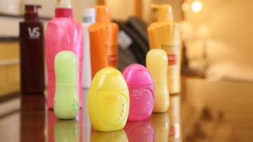 A selection of hair care products on a reflective surface.