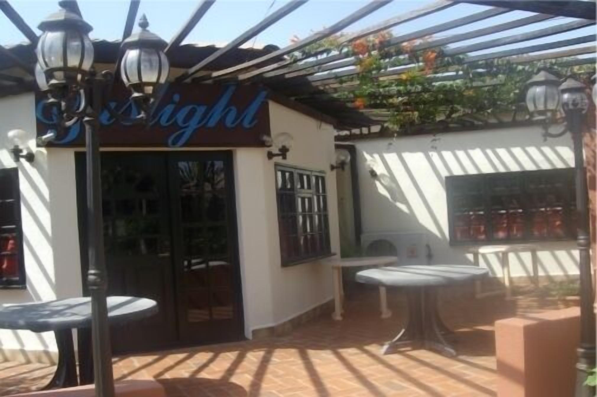A patio area with a sign reading "Light" and outdoor seating.