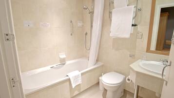 A bathroom with a bathtub, toilet, and sink.