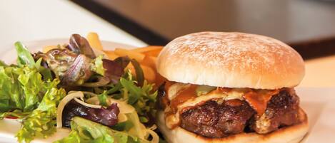A meal with a burger and fries, and a plate of salad.