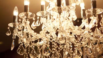 A chandelier with multiple crystal arms and bulbs.