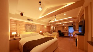 A spacious bedroom with a large bed, a desk, and a seating area. - Hotel Fine Garden Kyoto Minami (Kyoto)