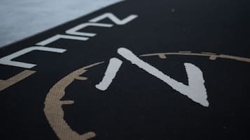 A black mat with white text and a symbol, possibly indicating a hotel or establishment.
