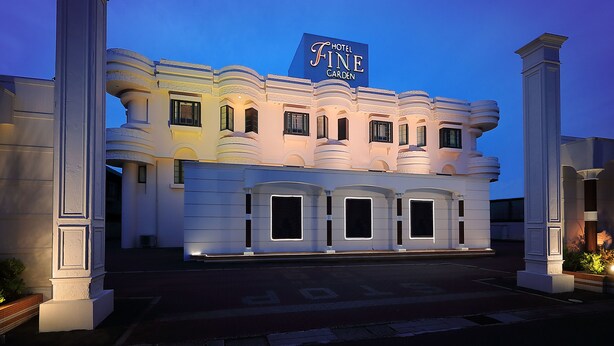Ein Hotel mit einem gut sichtbaren Schild, auf dem "Hotel Fine Garden" steht.