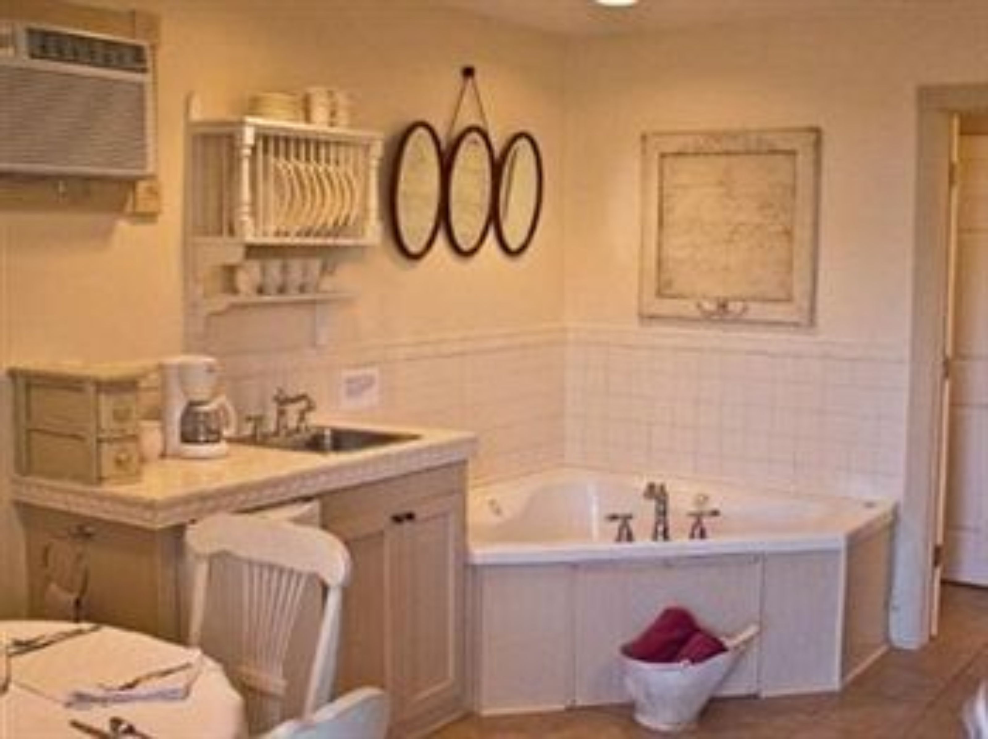 A bathroom with a sink, a mirror, a towel rack, and a bathtub.