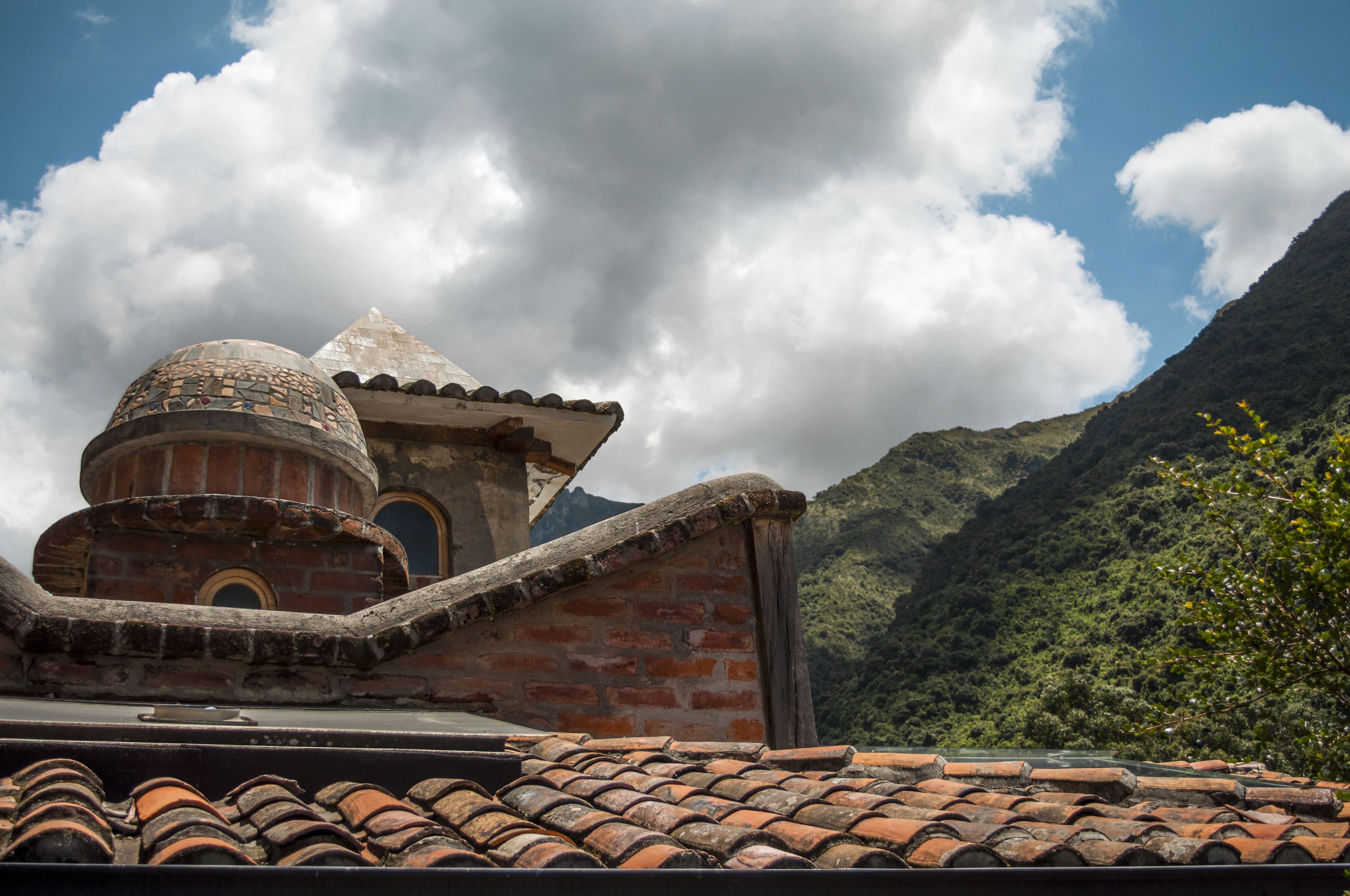 A building with a tiled roof and a dome structure.
