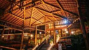 A spacious indoor area with a high ceiling and a staircase leading to upper levels.