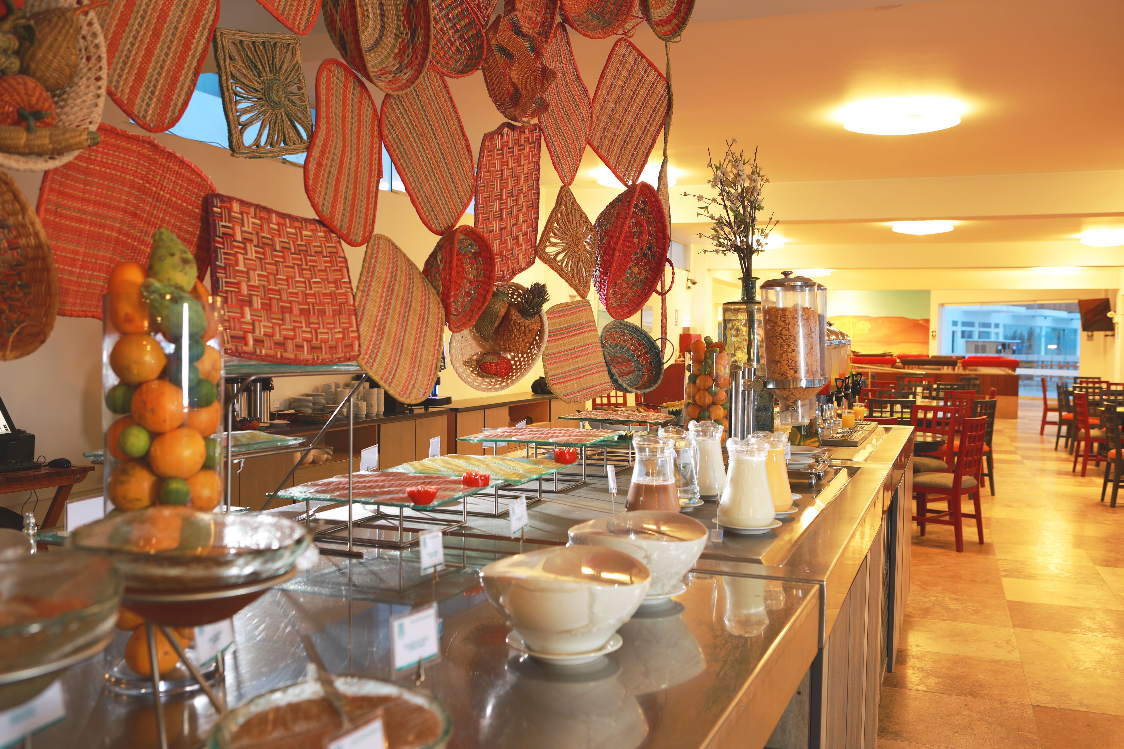 A buffet area with various food items and a bar.