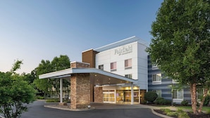 A Fairfield by Marriott hotel with a modern design, featuring a covered entrance and a landscaped driveway.