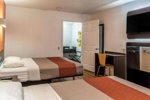 A hotel room with two beds, a desk, a chair, and a TV mounted on the wall. - Motel 6 Baltimore, MD (Baltimore)
