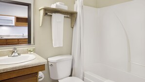 A bathroom with a sink, toilet, and shower. - WoodSpring Suites Washington DC Andrews AFB (Suitland)