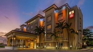 A hotel with a modern design, featuring a covered entrance and multiple floors. - Best Western Plus Miami Airport North Hotel & Suites (Miami Springs)