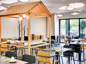 Guests can enjoy meals and snacks in this dining area with tables and chairs.
