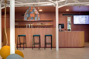 Welcome to our reception area, where a unique lamp and comfortable seating set the tone for a warm stay.
