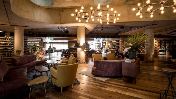 A spacious lobby with wooden flooring, modern seating, and a unique ceiling design. - Ovolo Canberra, a Wyndham Hotel (Canberra)