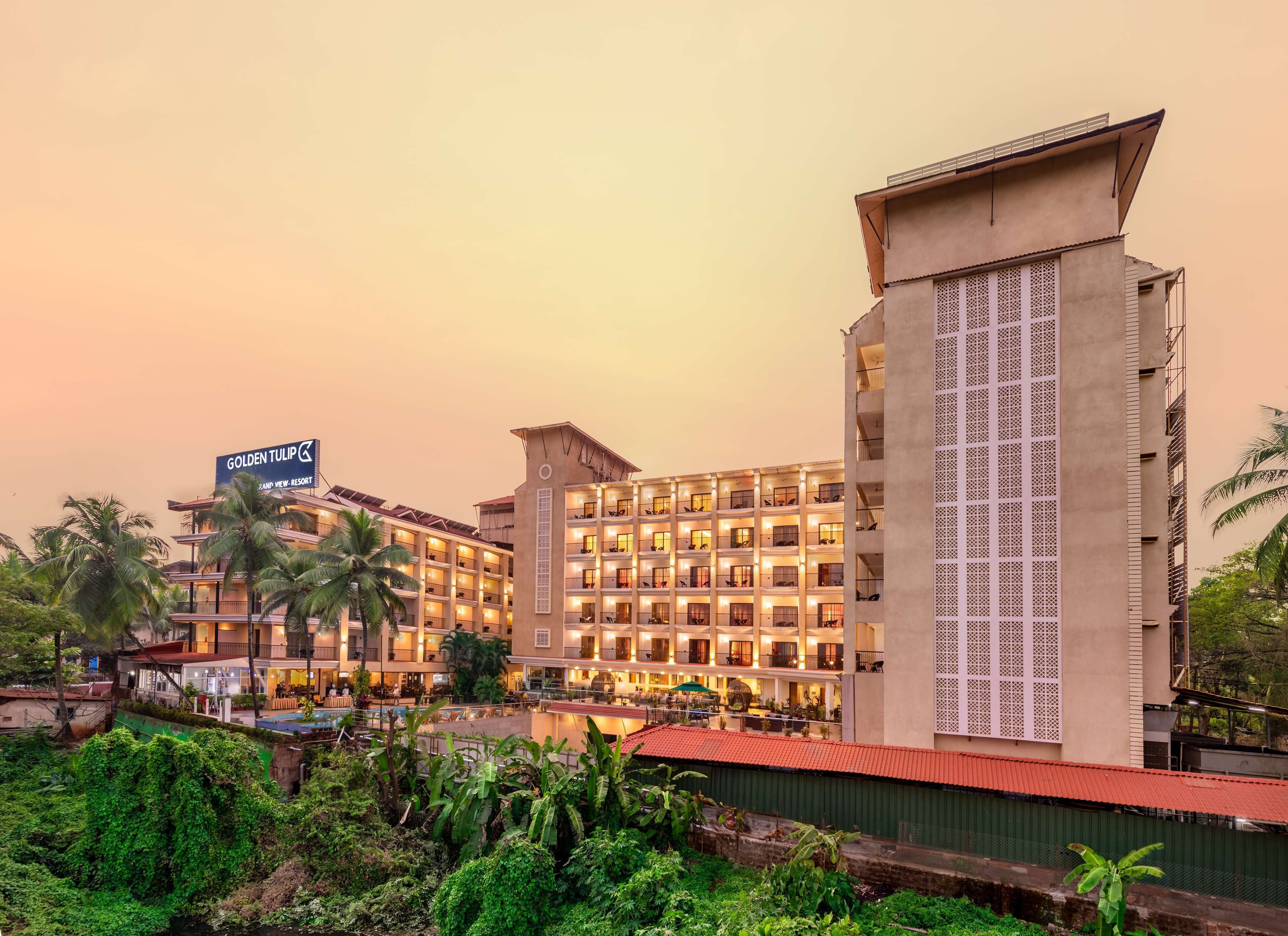 A multi-story hotel with a prominent sign reading "Golden Tulip Grand View Resort."