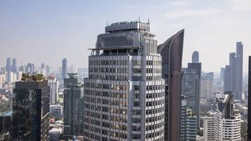 A high-rise building with a unique architectural design, featuring a curved facade and multiple balconies.