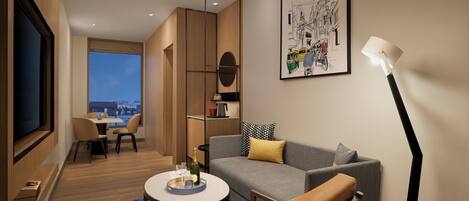 A modern living room with a sofa, armchair, and coffee table, a dining area with chairs, a TV, and a large window offering a city view.