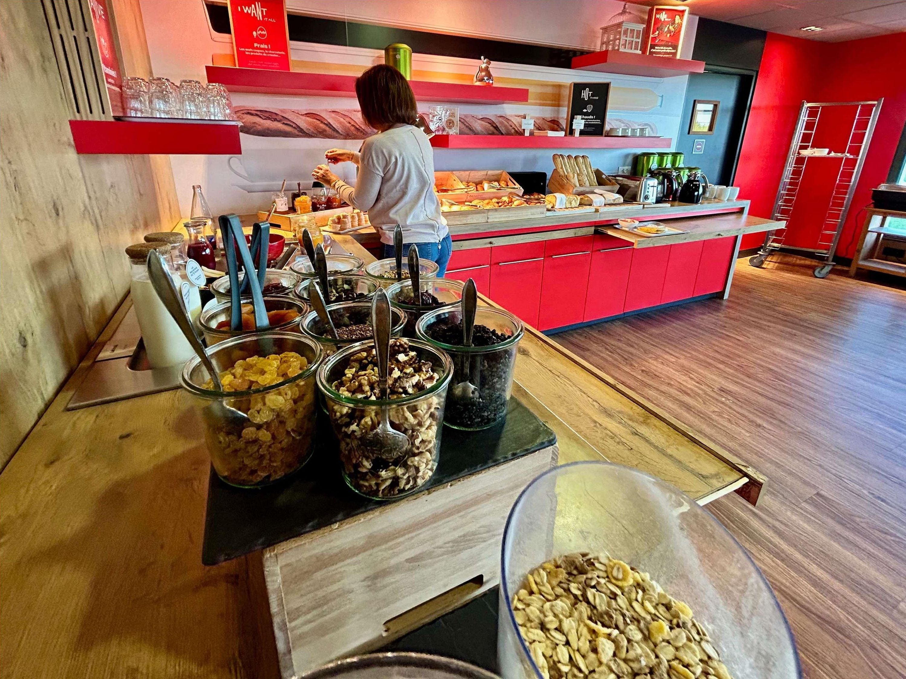 A buffet area with various food items and a person serving.