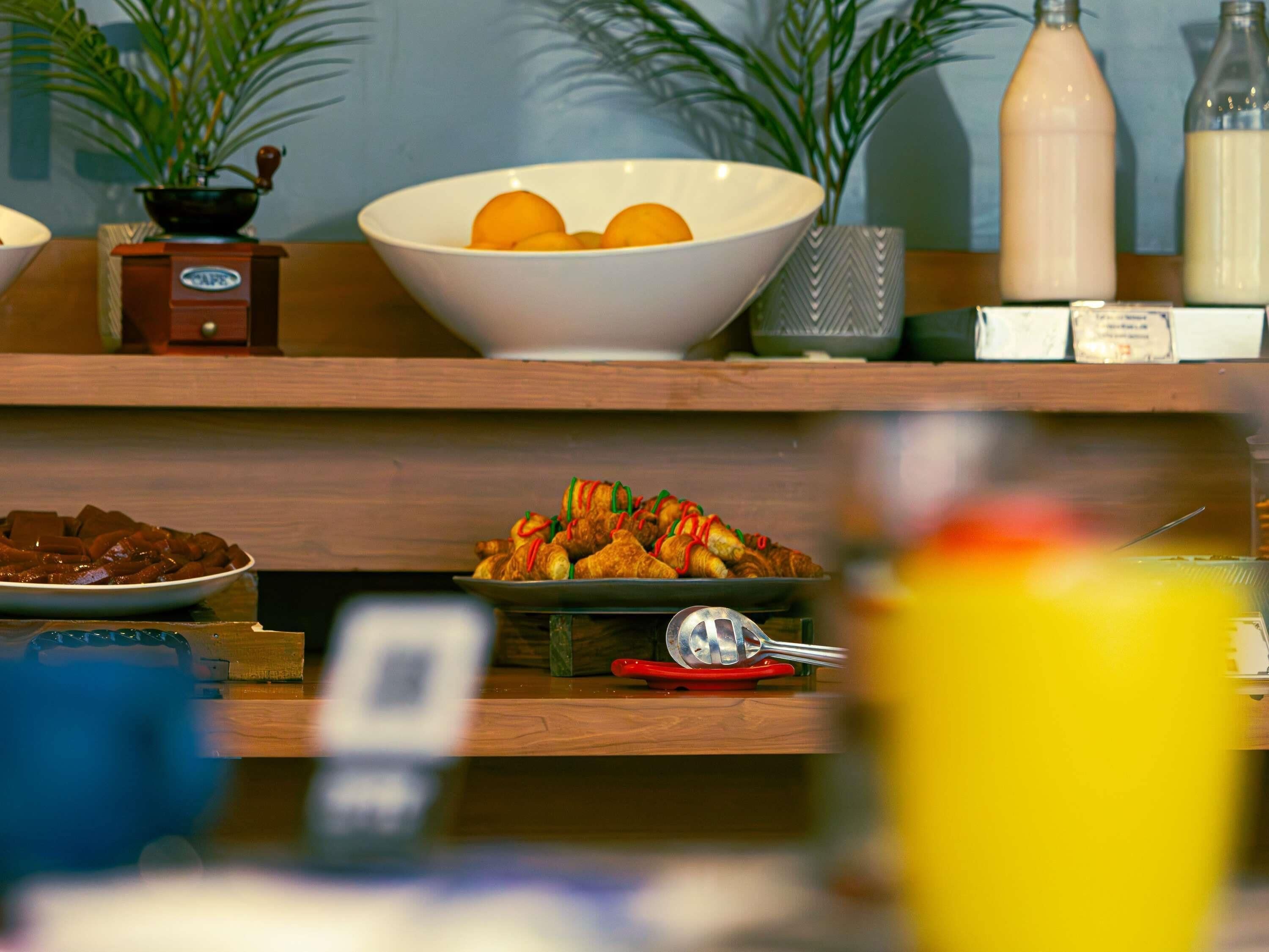 A buffet setup with various food items and condiments.