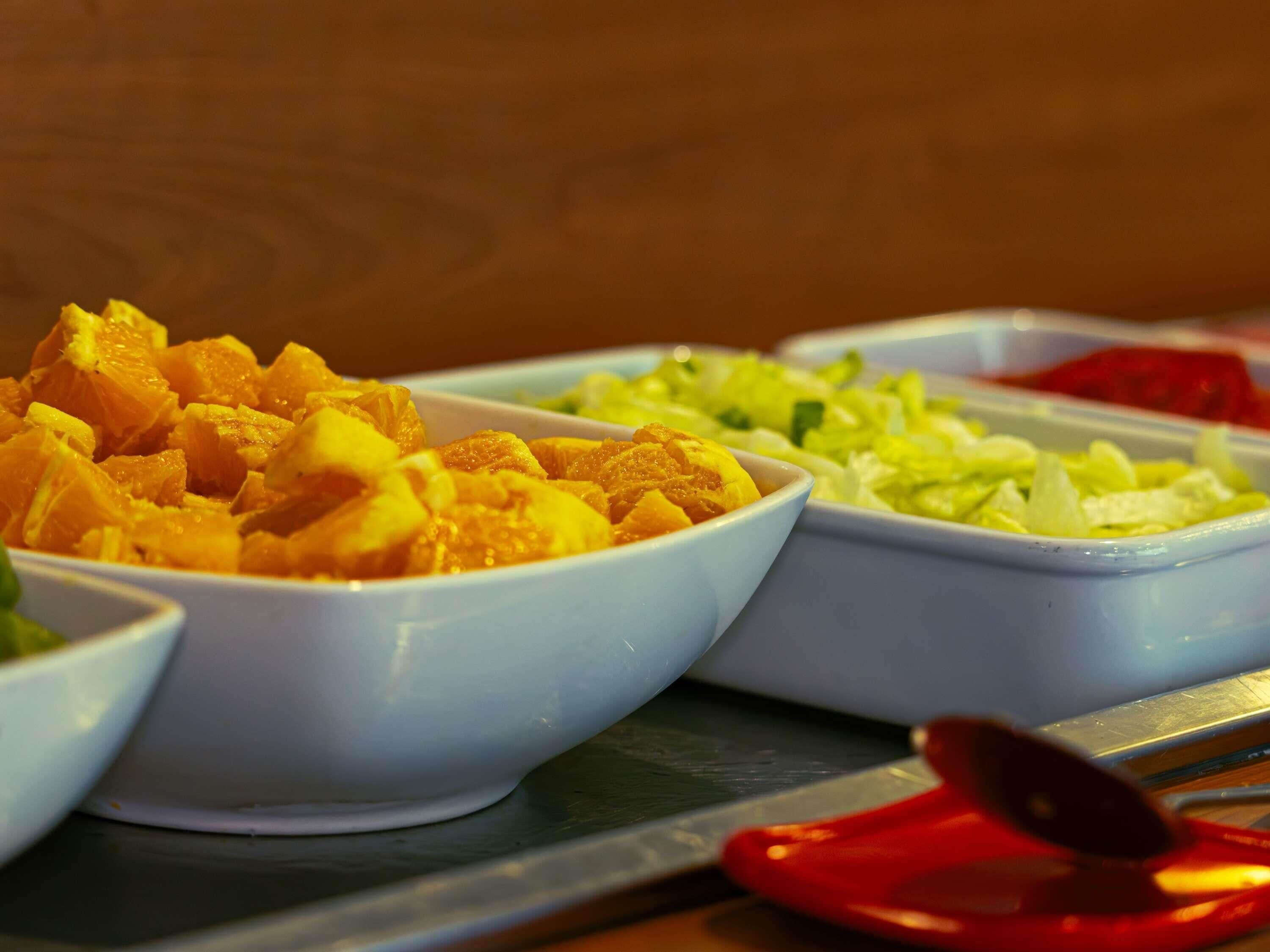 A table with three bowls containing different food items.