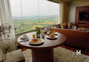 Presidential Suite | Living area | 42-inch LED TV with satellite channels, TV, iPod dock