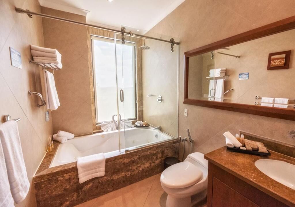 deluxe room, bathtub | bathroom | hair dryer, towels