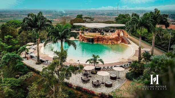 A resort with a large pool, outdoor seating, and a view of the landscape. - Hillary Nature Resort Spa (Arenillas)