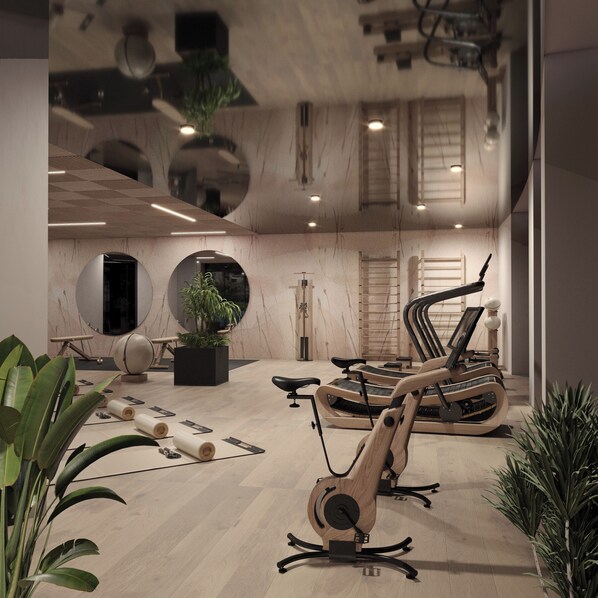 Quarto moderno e bem iluminado, com equipamentos de ginástica, um espelho grande e um vaso de planta.