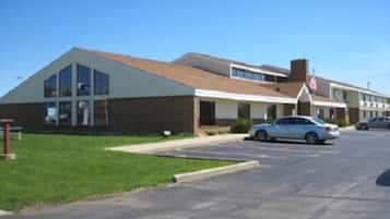 A two-story building with a flat roof and large windows.