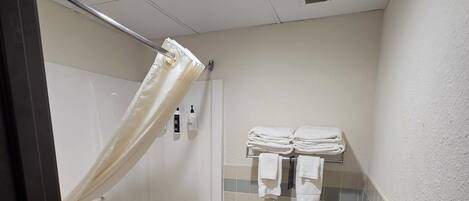 A bathroom with a bathtub, toilet, and shower curtain.
