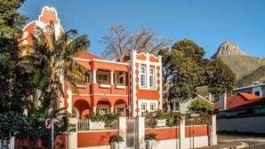 A red and white building with arched windows and a gated entrance.
