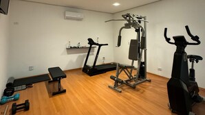 A gym with treadmills, a bench, dumbbells, and a stationary bike. - Estrela da Água Fria (São Paulo)